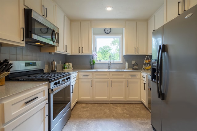 6611 Crooked Creek Rd, Tallahassee, FL 32311 - kitchen featuring stainless steel appliances, light countertops, decorative backsplash, white cabinetry, and concrete flooring