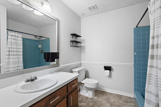 bathroom with toilet, vanity, and walk in shower