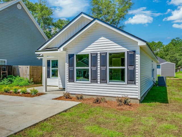 view of front of home featuring a front yard and central air condition unit