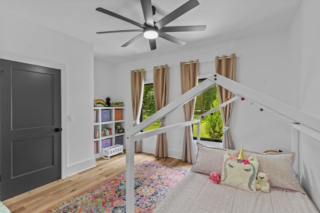 bedroom with hardwood / wood-style floors and ceiling fan