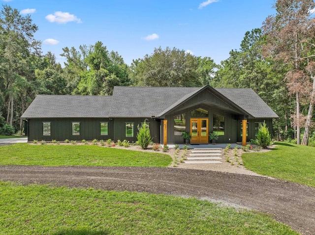 view of front facade with a front lawn and french doors