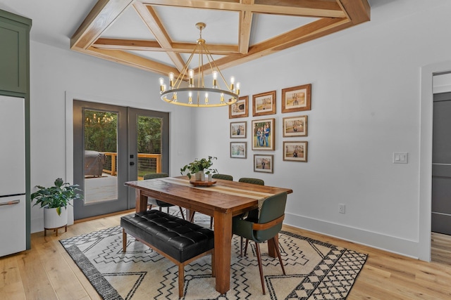 dining area with french doors, light hardwood / wood-style floors, coffered ceiling, an inviting chandelier, and beamed ceiling