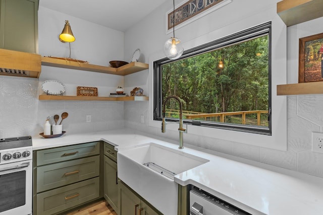 kitchen featuring sink, decorative light fixtures, a healthy amount of sunlight, and stainless steel electric stove