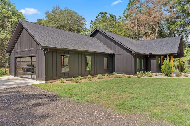 view of front of house with a garage and a front lawn