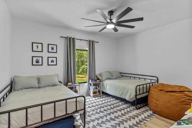 bedroom with ceiling fan and hardwood / wood-style flooring