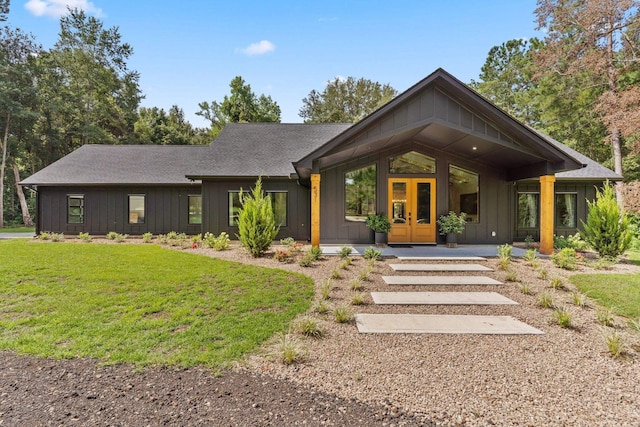 view of front of property featuring a front yard and french doors