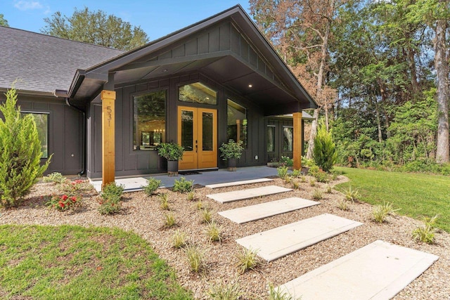 doorway to property with french doors and a lawn