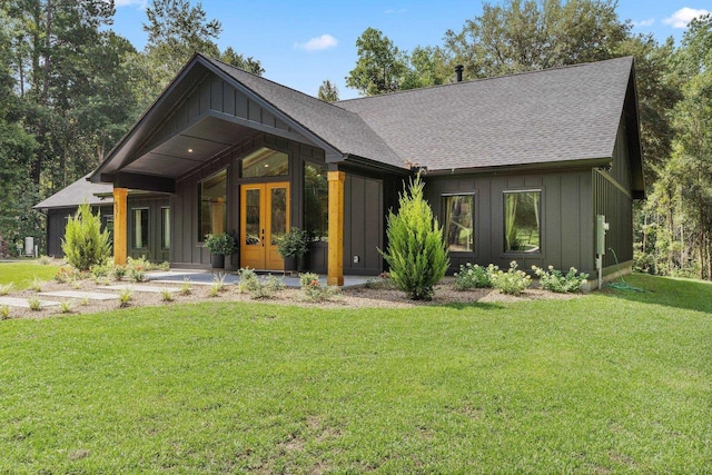 back of house with a yard and french doors