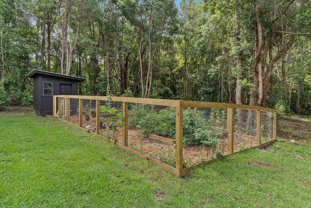 view of gate with a yard and a storage shed