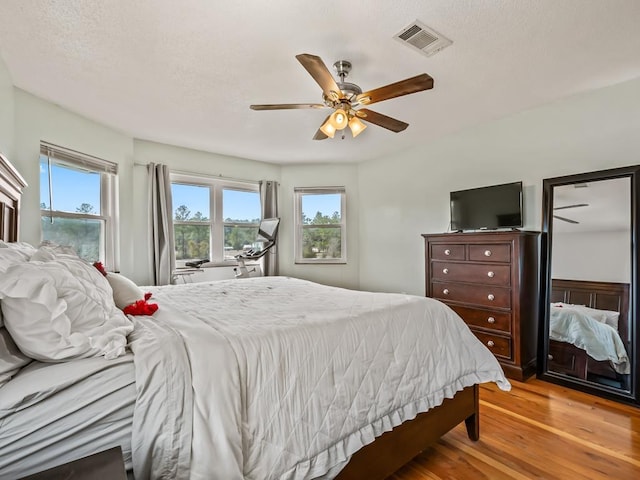 bedroom with light hardwood / wood-style flooring and ceiling fan