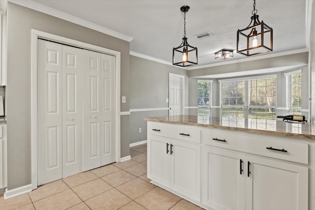 kitchen featuring white cabinetry, light tile patterned floors, ornamental molding, baseboards, and visible vents