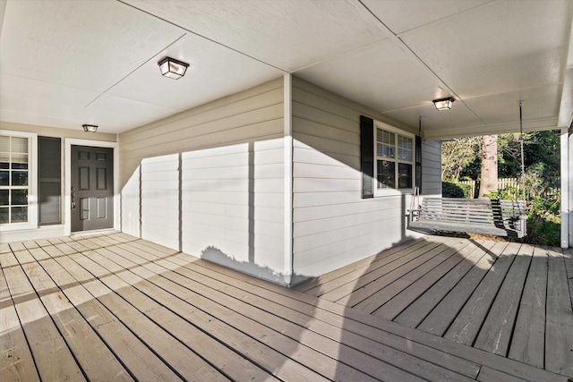 wooden terrace featuring covered porch