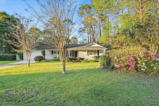 single story home featuring a front lawn, a garage, and concrete driveway