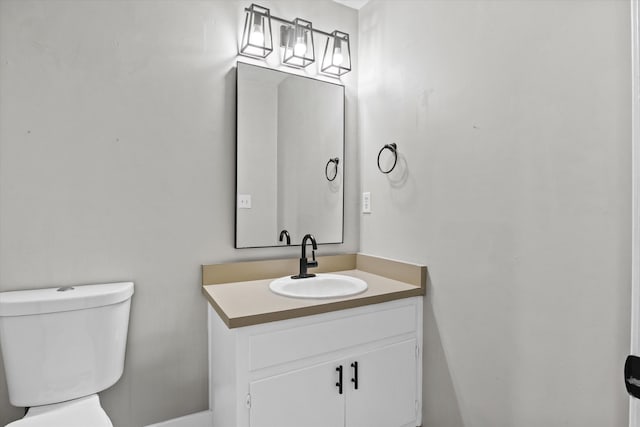 bathroom with toilet and vanity