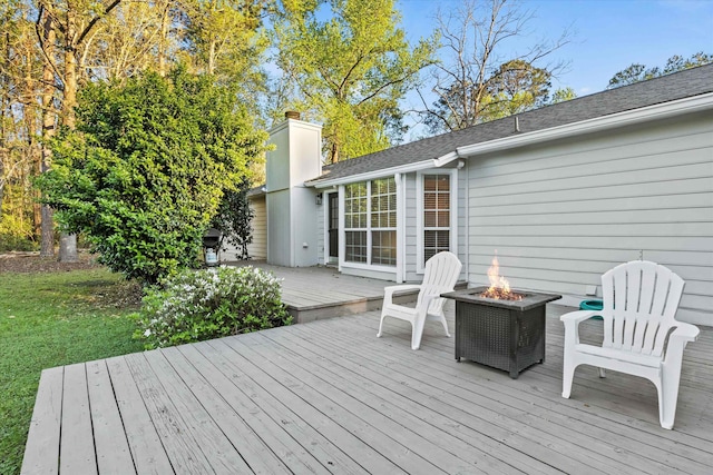 wooden deck with a fire pit