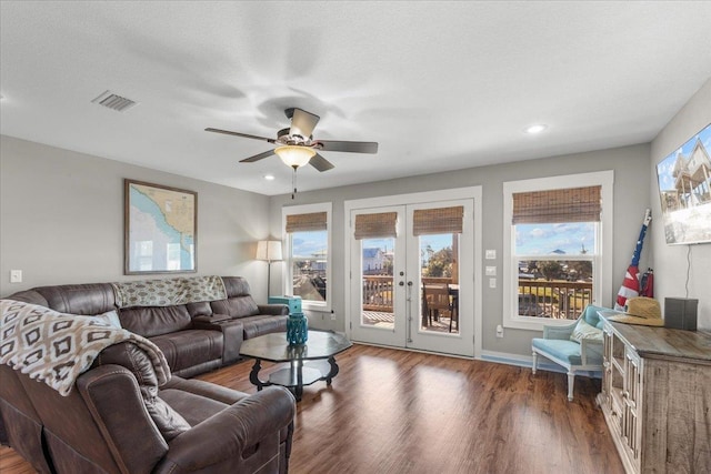 living room with french doors, ceiling fan, dark hardwood / wood-style floors, and a textured ceiling