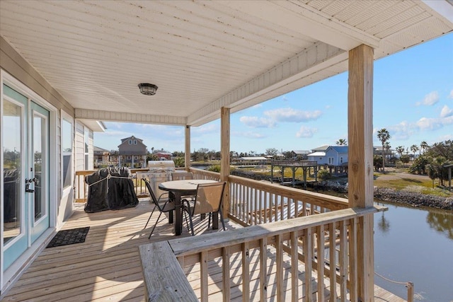 wooden deck featuring a water view