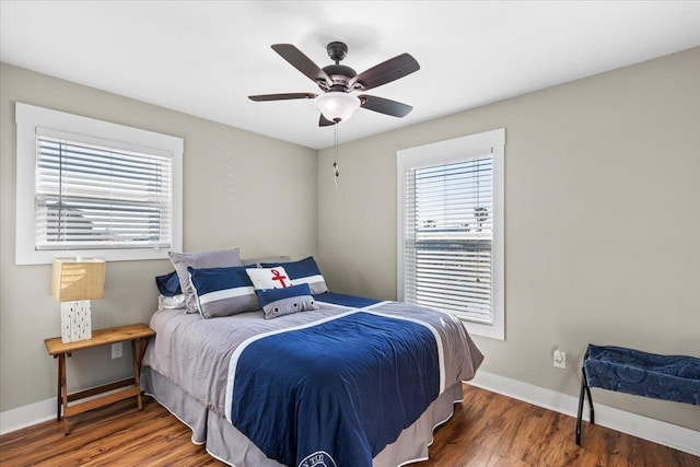 bedroom with dark wood-type flooring and ceiling fan