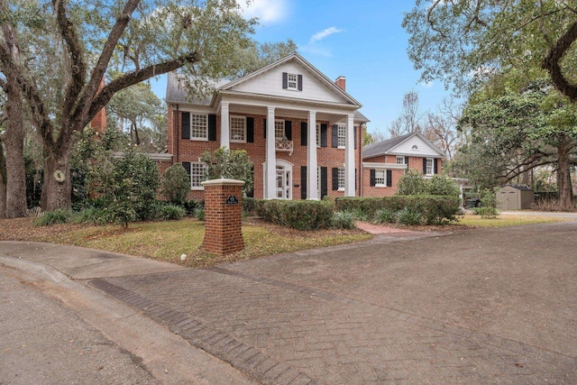 neoclassical / greek revival house with a storage shed