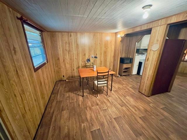 16872 Aqua Ln, Tallahassee, FL 32310 - dining room with washer / clothes dryer, wood walls, and wood finished floors