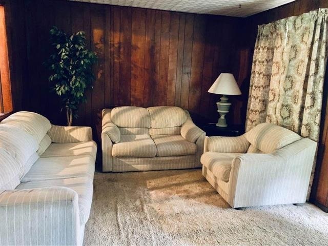 16872 Aqua Ln, Tallahassee, FL 32310 - living area featuring carpet floors and wood walls