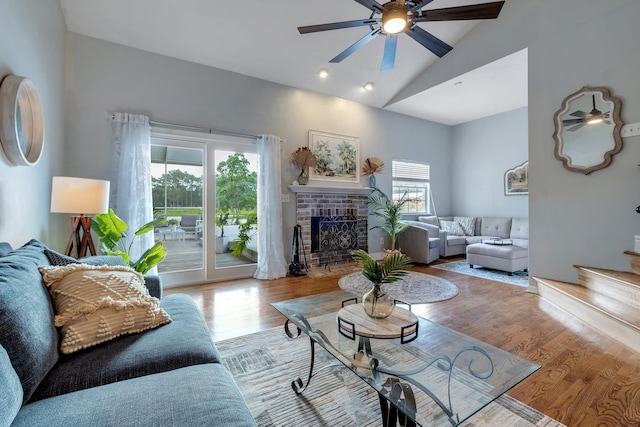 6509 Alan A Dale Trl, Tallahassee, FL 32309 - living room with wood finished floors, a fireplace, ceiling fan, high vaulted ceiling, and stairway