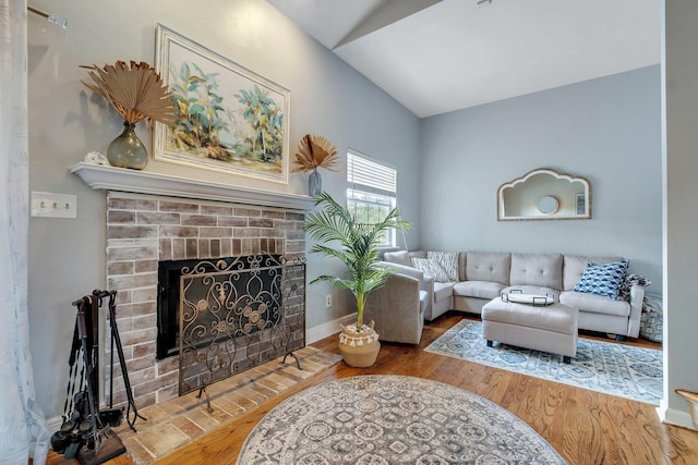6509 Alan A Dale Trl, Tallahassee, FL 32309 - living room with vaulted ceiling, a fireplace, and wood finished floors