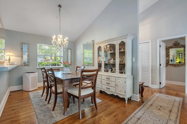 6509 Alan A Dale Trl, Tallahassee, FL 32309 - dining area with a chandelier, wood finished floors, and high vaulted ceiling