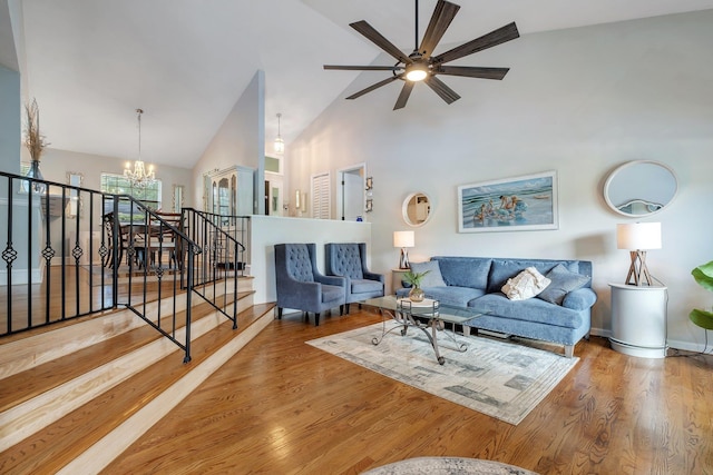 6509 Alan A Dale Trl, Tallahassee, FL 32309 - living area featuring a chandelier, a ceiling fan, high vaulted ceiling, wood finished floors, and stairs
