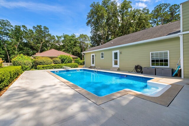 6509 Alan A Dale Trl, Tallahassee, FL 32309 - swimming pool featuring a patio area, entry steps, a diving board, and view of scattered trees