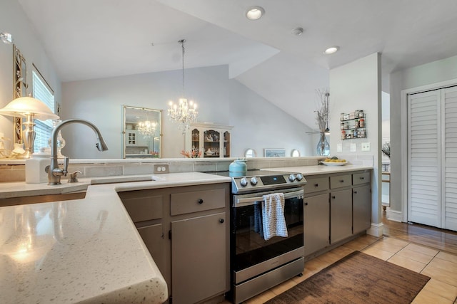 6509 Alan A Dale Trl, Tallahassee, FL 32309 - kitchen featuring stainless steel range with electric cooktop, a chandelier, gray cabinetry, vaulted ceiling, and hanging light fixtures