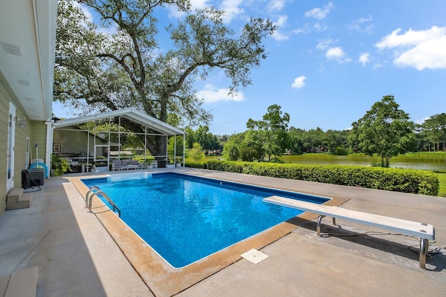 6509 Alan A Dale Trl, Tallahassee, FL 32309 - outdoor pool with a patio, a diving board, a water view, and view of wooded area