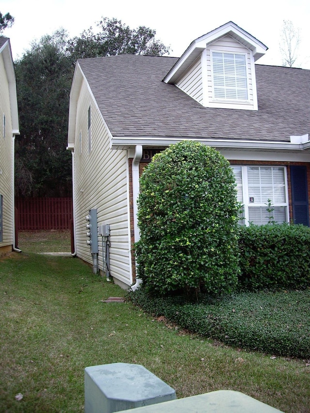 view of home's exterior with a shingled roof