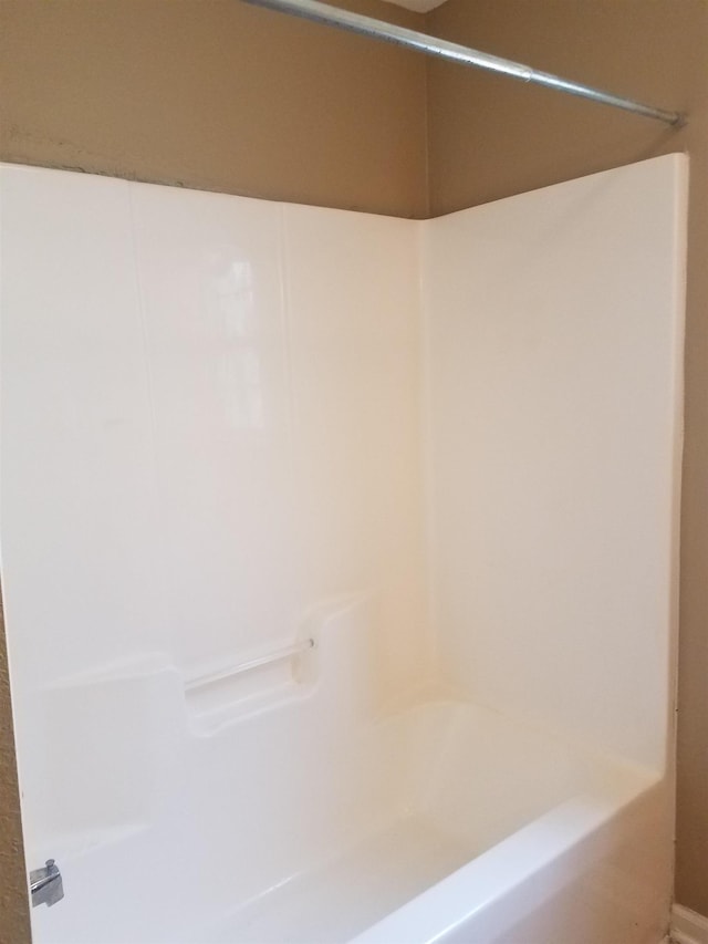 bathroom with a shower and a tub