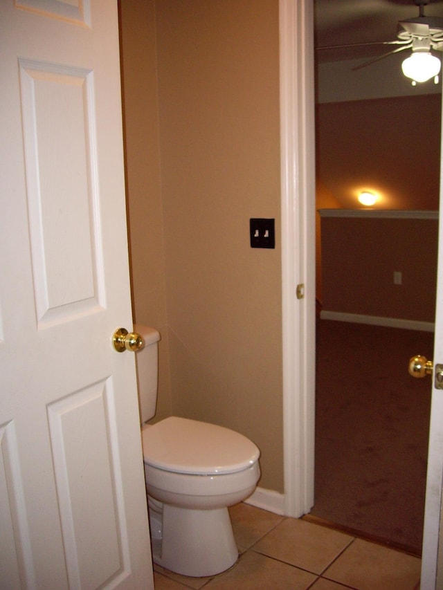 bathroom featuring tile patterned flooring, ceiling fan, toilet, and baseboards