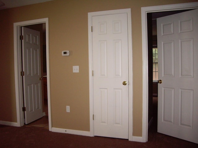 unfurnished bedroom with carpet floors and baseboards
