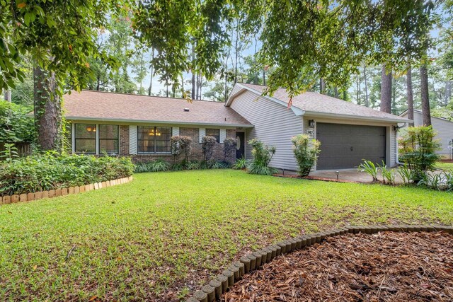 3412 Edgemont Trl, Tallahassee, FL 32312 - view of front of home with a front lawn, an attached garage, and roof with shingles