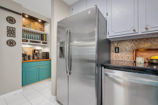 3412 Edgemont Trl, Tallahassee, FL 32312 - kitchen with appliances with stainless steel finishes, light tile patterned floors, tasteful backsplash, butcher block countertops, and open shelves