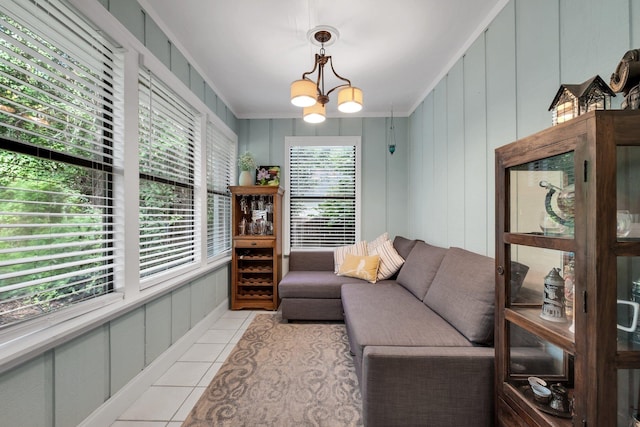 3412 Edgemont Trl, Tallahassee, FL 32312 - living room with light tile patterned flooring, crown molding, a chandelier, and a decorative wall