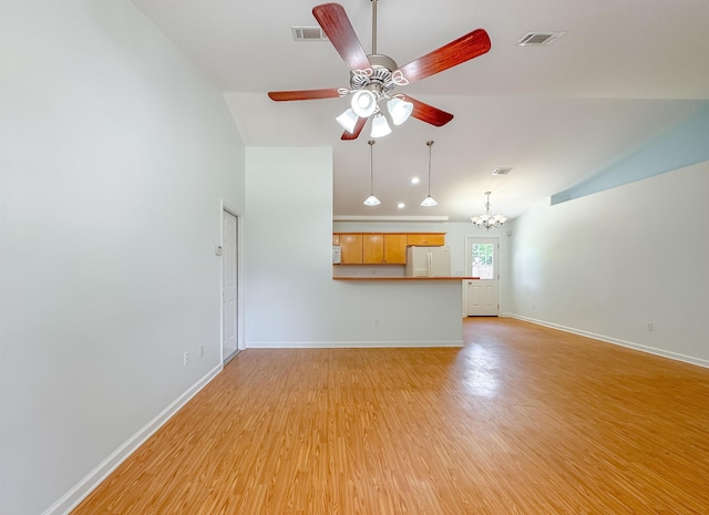 unfurnished living room featuring light wood-style floors, baseboards, lofted ceiling, and ceiling fan with notable chandelier