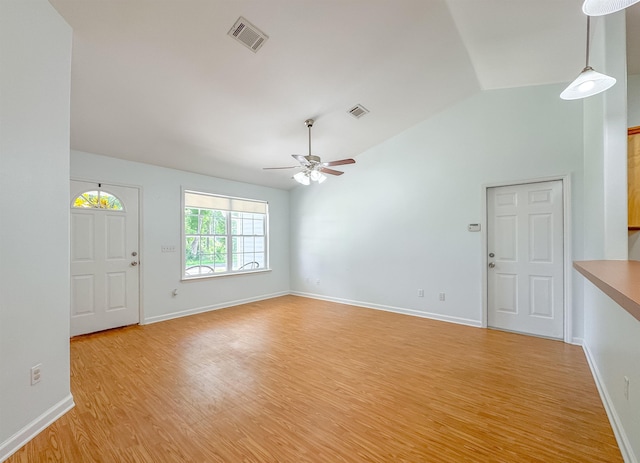 unfurnished living room featuring ceiling fan, vaulted ceiling, light wood finished floors, and visible vents