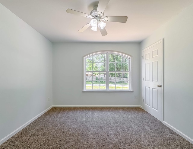 unfurnished room featuring carpet floors, a ceiling fan, and baseboards