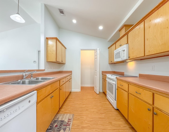 kitchen featuring visible vents, vaulted ceiling, a sink, light countertops, and white appliances