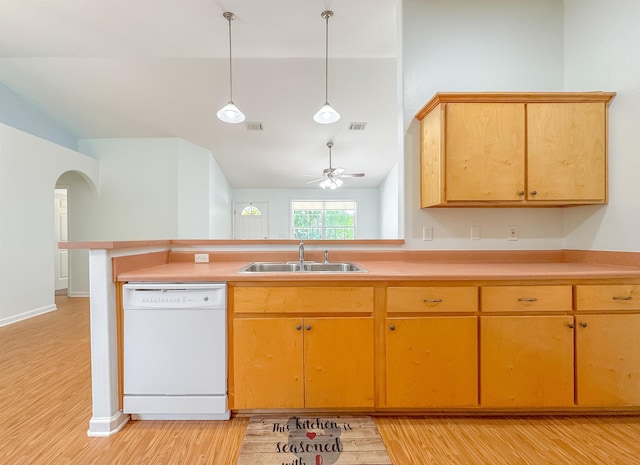 kitchen with ceiling fan, white dishwasher, arched walkways, a sink, and light wood-style floors