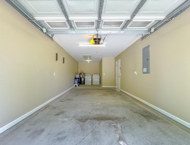 garage with baseboards, a garage door opener, electric panel, and washing machine and clothes dryer