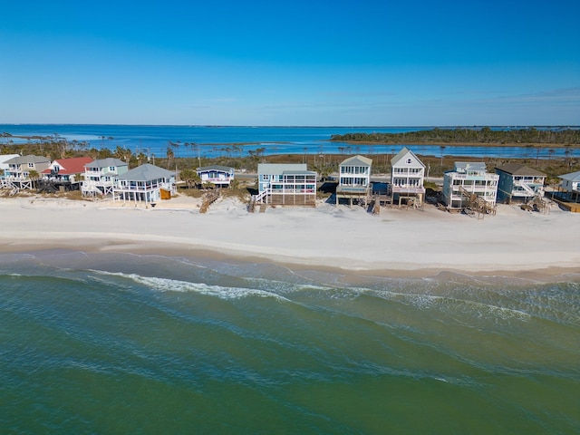 drone / aerial view with a water view and a beach view