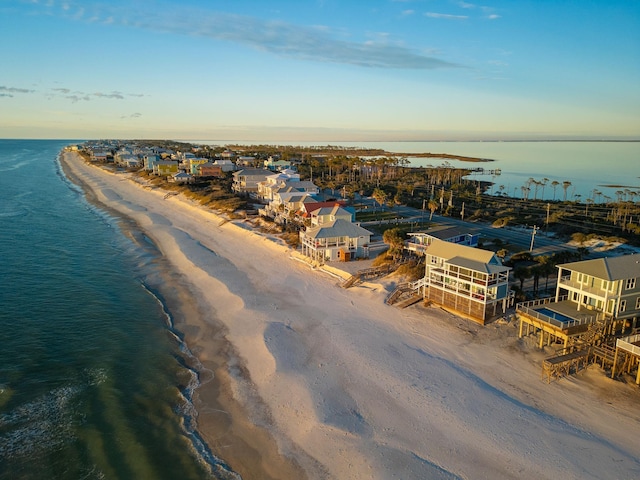 bird's eye view with a water view and a beach view