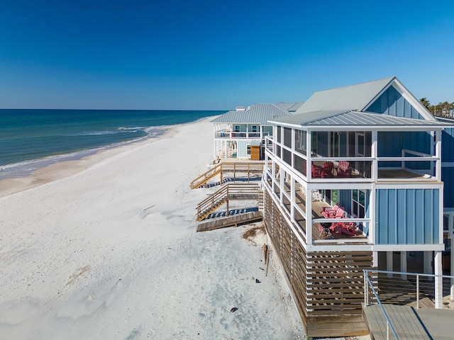 exterior space with a water view and a view of the beach