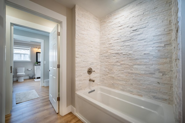 bathroom with toilet and hardwood / wood-style floors