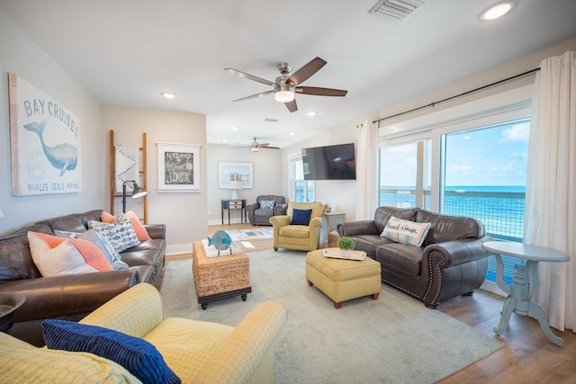 living room with hardwood / wood-style floors and ceiling fan